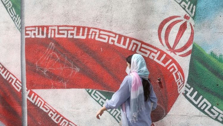 Iranian woman walks in a street in Tehran