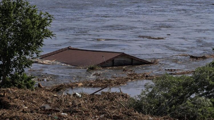 Roof of a house is seen in the Dnipro river which flooded after the Nova Kakhovka dam breached,, in Kherson