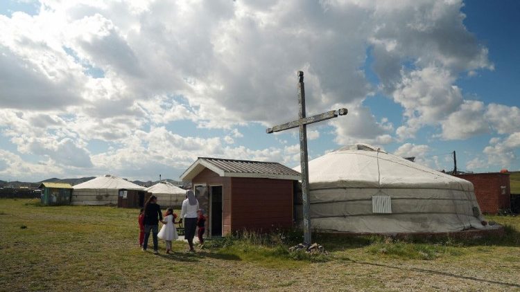 A religious sister walks with children outside the Our Mother of Mercy Mission church near Arvaikheer, Mongolia