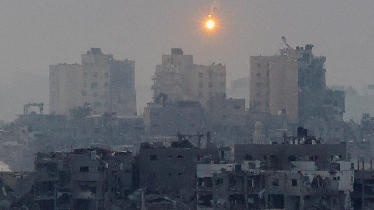 Flares burn above Gaza, as seen from southern Israel