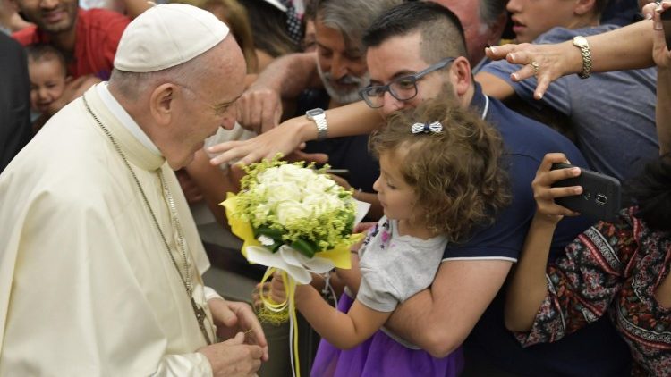 Pope Francis greets a child at the General Audience