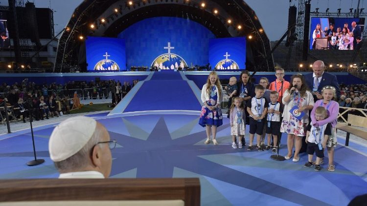 Pope Francis listens to a family giving a testimony during the Festival of Families