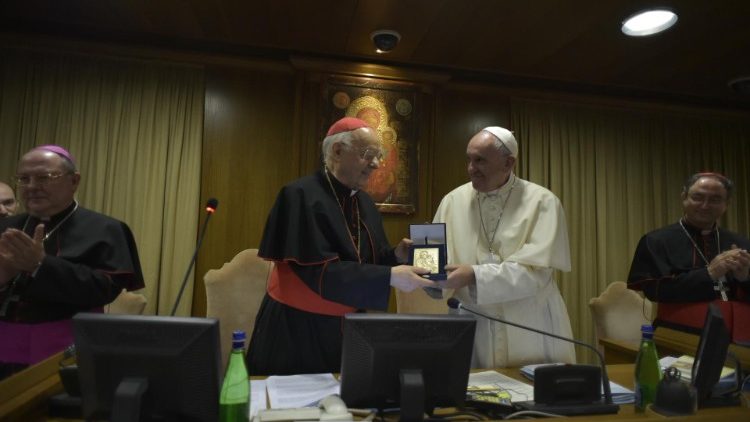 Pope Francis showing his souvenir gift to Synod participants.
