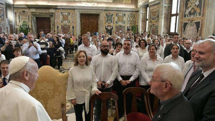 Pope Francis listens to the 'Alumni of Heaven' choir members