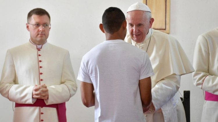 Pope Francis greets an inmate at the Pacora Juvenile Detention Center