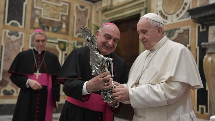 Pope Francis is handed a statue of Our Lady of the Ribbon