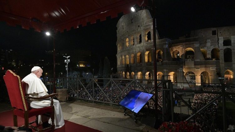 Pope Francis sits in front of the Colosseum