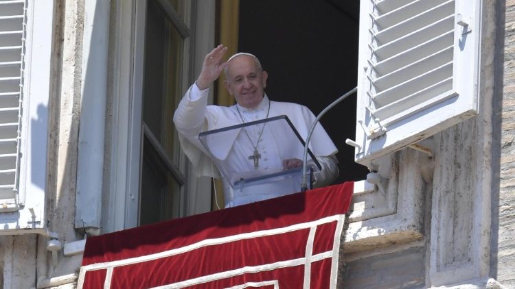 Pope waves to pilgrims in St Peter's Square during the Angelus