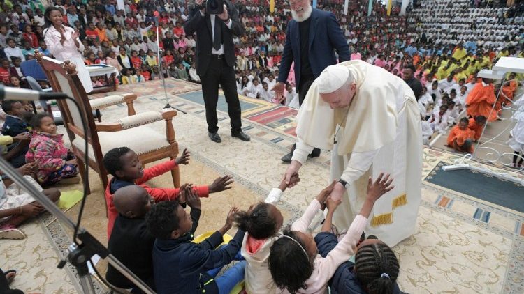 Pope Francis greets children at the Akamasoa Association