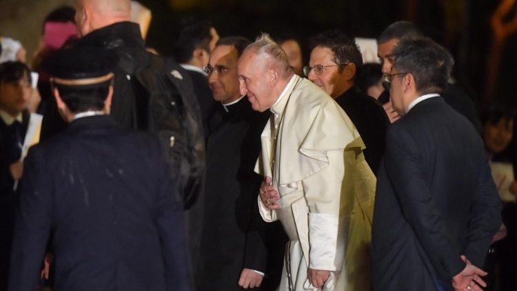 Pope Francis smiles as he walks onto Japanese soil