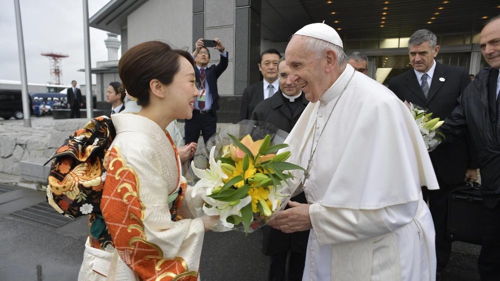 Pope Francis receives flowers from Japanese woman dressed in a traditional kimono