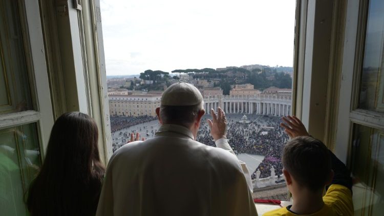 Pope Francis greets the crowds from the balcony overlooking St. Peter's Square