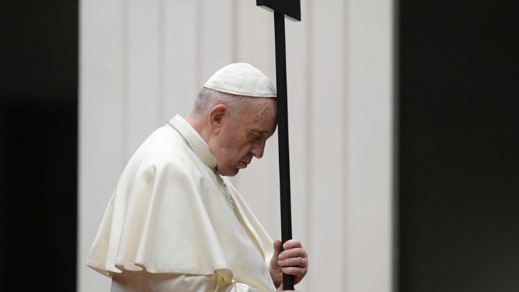 Pope Francis holding the cross during Friday evening's Via Crucis