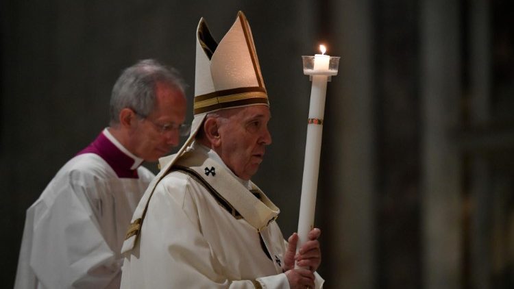 Pope Francis carrying a candle at the beginning of the Easter Vigil