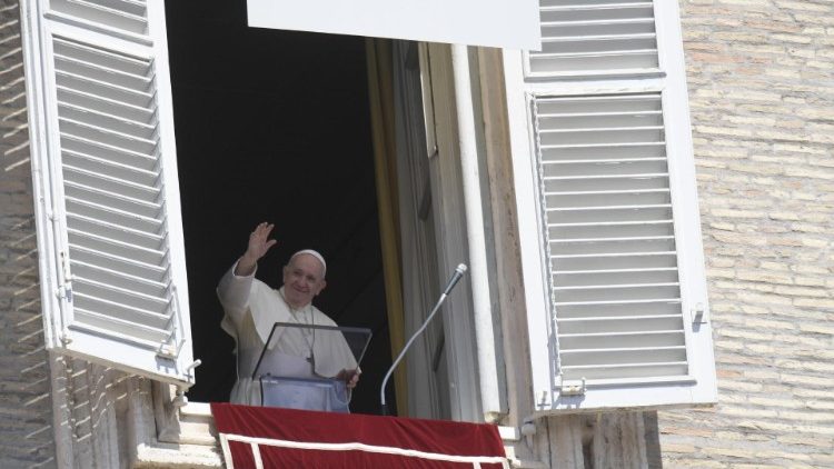 Pope Francis waves to pilgrims and visitors during the Sunday Angelus