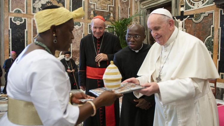 Pope Francis receives a gift from a member of the International Catholic Legislators Network
