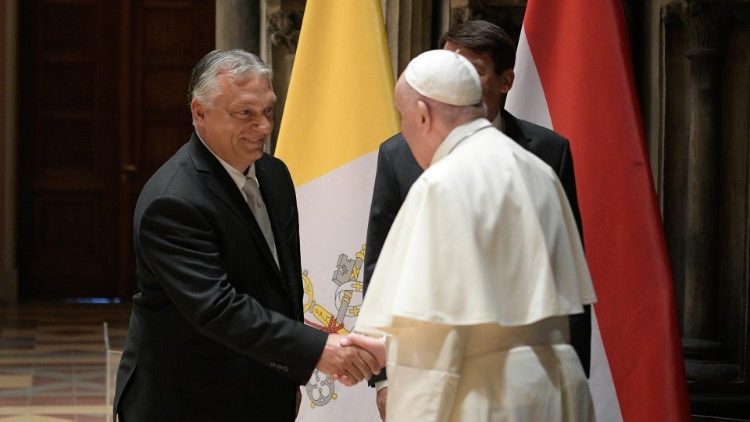 Pope Francis shakes hands with PM Orban