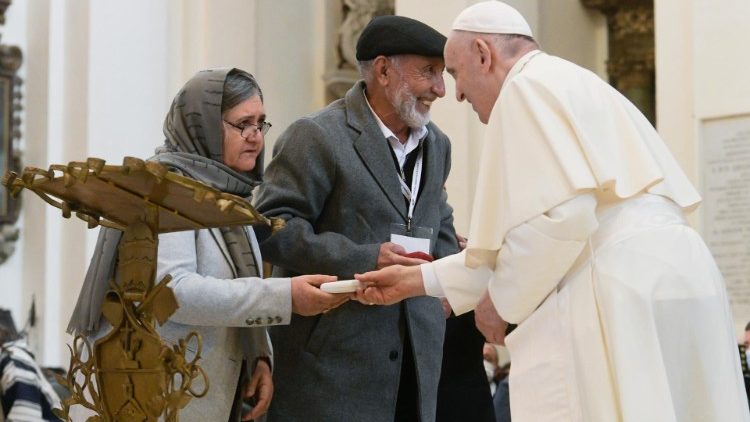 The Pope greets a couple at the prayer service