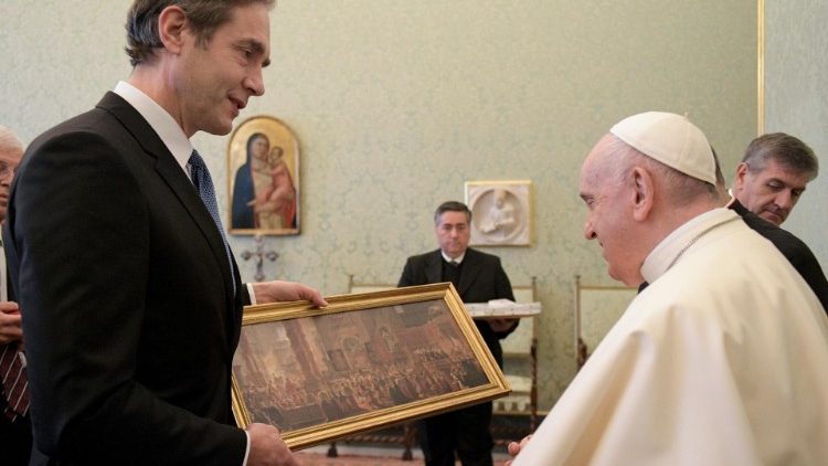 Pope Francis is presented with a gift during the audience