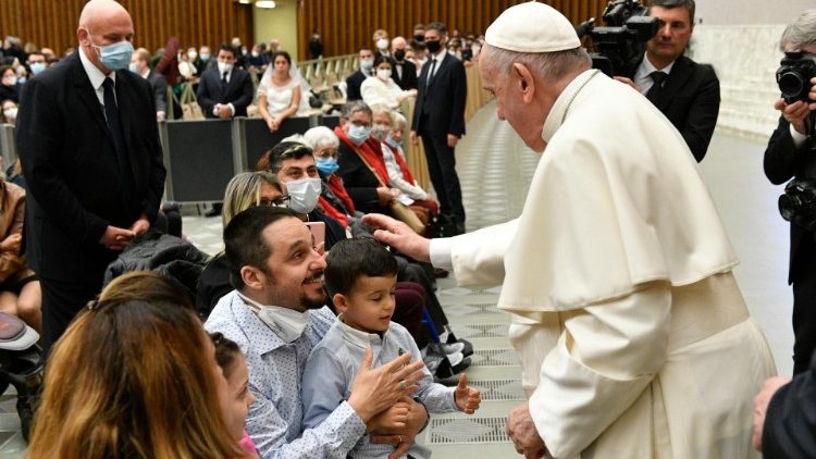 The Pope greets a father and son at the Audience