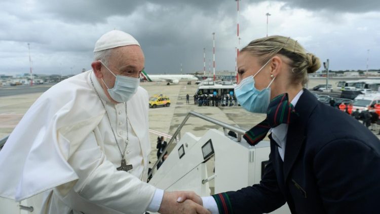 Папа Франциск вітається з бортпровідницею перед посадкою на літак