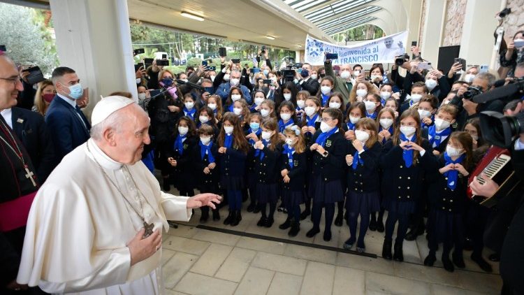 School children welcome Pope Francis to the venue