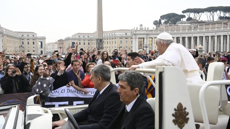 Pope Francis waves to pilgrims