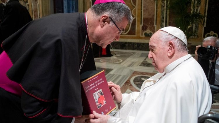 A bishop presents the Pope with a book