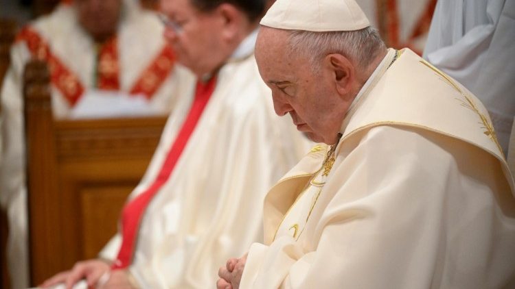 Pope Francis prays at Mass