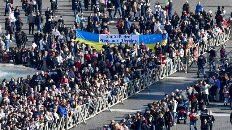 A banner with the colours of the Ukrainian flag is held up during the "Urbi et Orbi" blessing