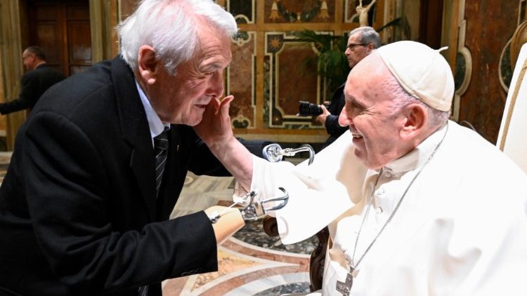 Pope Francis greetings one of the members of the Italy's association for disabled veterans and civil servants