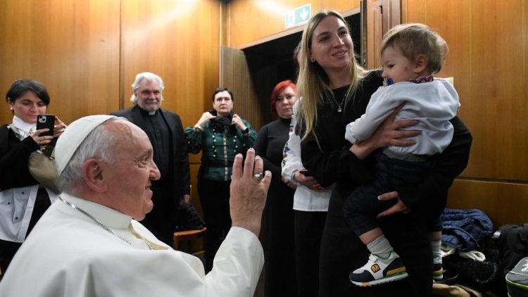 Pope Francis greets a Ukrainian child