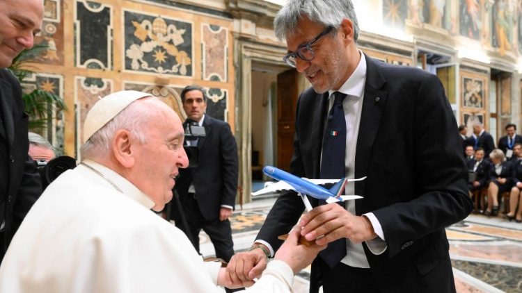 Pope Francis is given a model of an ITA aeroplane during his audience with ITA Airways staff in the Vatican