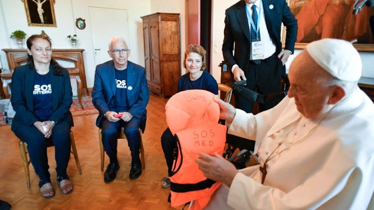 MAP Francis holds a lifejacket