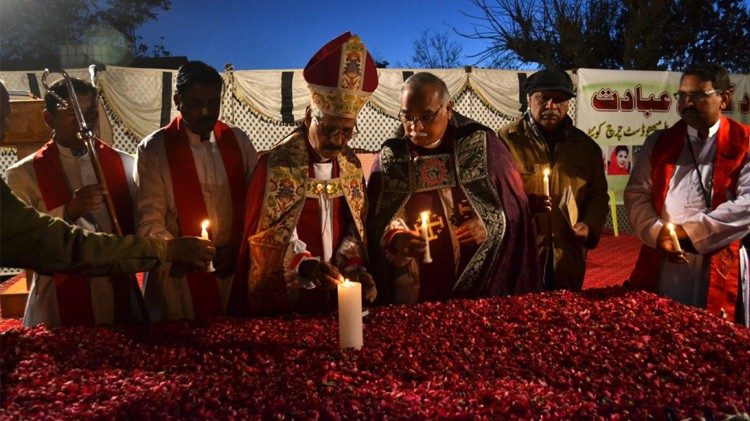 Pakistanska kristna präster tänder ljus