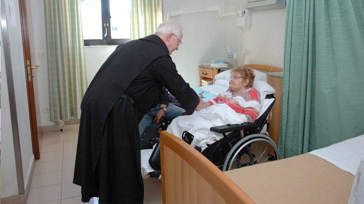 A member of the Brothers Hospitallers of Saint John of God cares for a patient