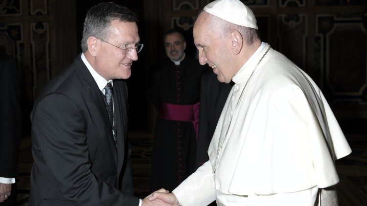 Pope Francis shakes hands with Brian Grim