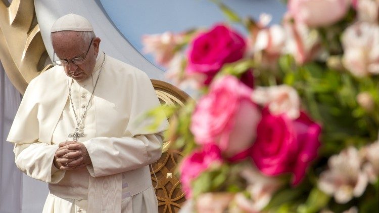 Pope Francis bows his head in prayer