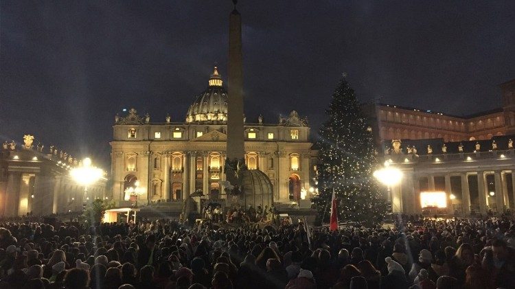 View of St Peter's Square with Nativity scene and Christmas tree in the foreground. 