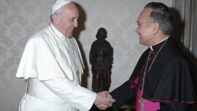 Archbishop Edgar Peña Parra shakes hands with Pope Francis