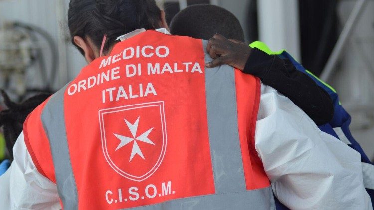 A Sovreign Order of Malta doctor in the field assisting a migrant