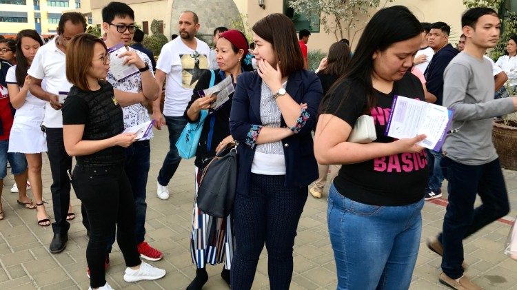Catholics queue at St. Joseph's Cathedral in Abu Dhabi to receive free tickets for the Pope's Mass