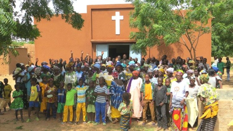 Christians in Burkina Faso gather around their church