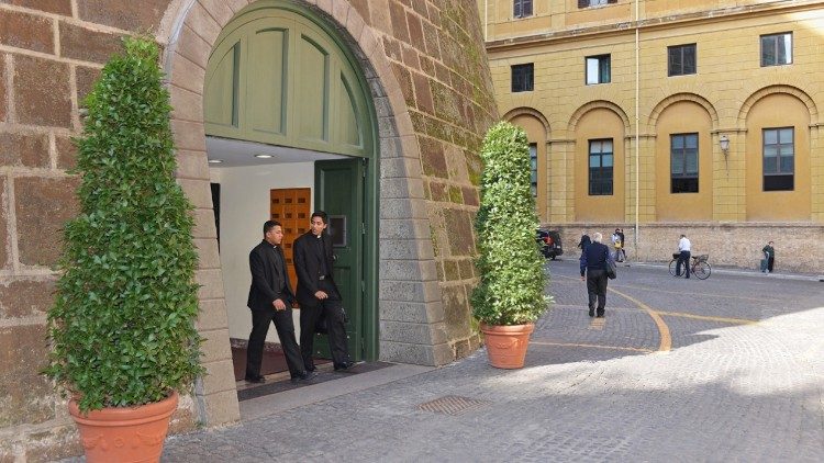 Two clients exit the Vatican Bank