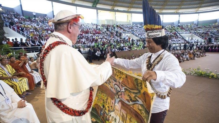 Pope Francis accepts a gift from a person from the Amazon region
