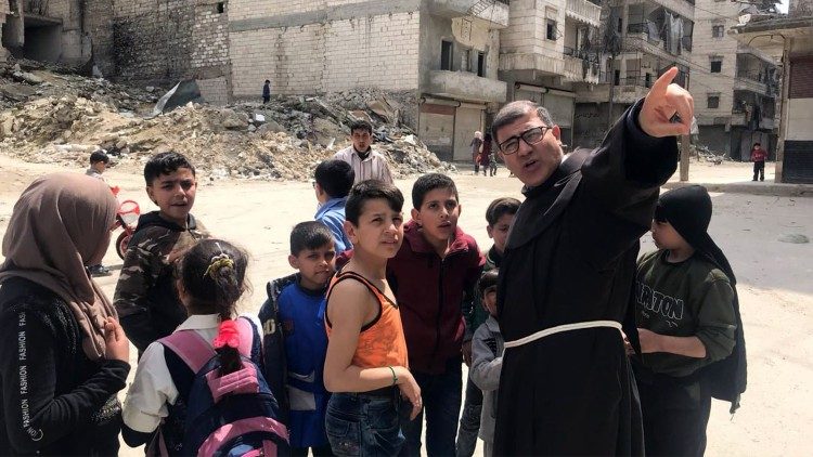 Father Firas Lufti with the children of Aleppo
