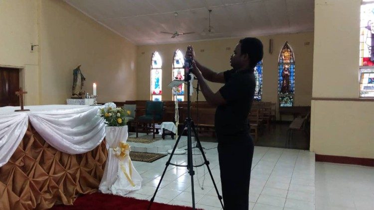 Joseph Phiri, a youth at St Theresa's Cathedral, Livingstone, Zambia setting up for live streaming of the Eucharist