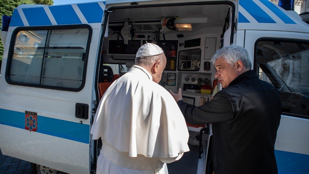 Cardinal Krajewski shows the ambulance to the Pope