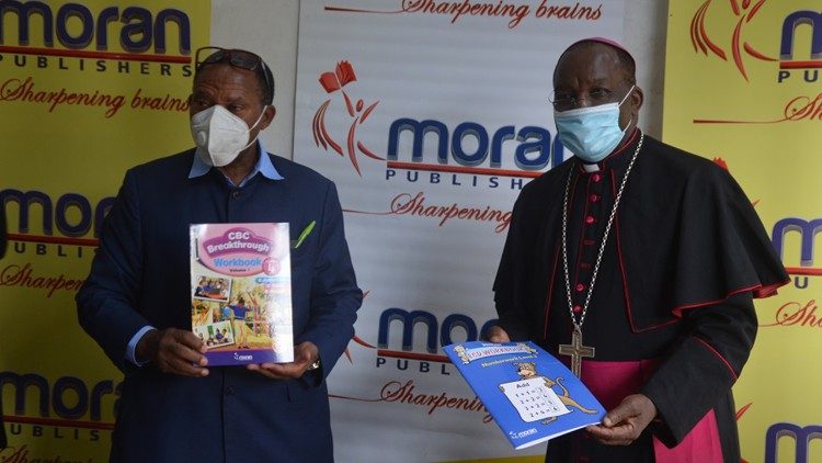 Moran Publishers CEO, David Muita with the KCCB– Caritas Kenya Chairman, Archbishop Kivuva 