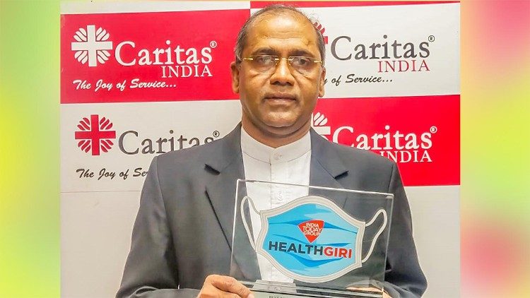 Executive Director of Caritas India Father Paul Moonjely with the Healthgiri Awards 2020. 